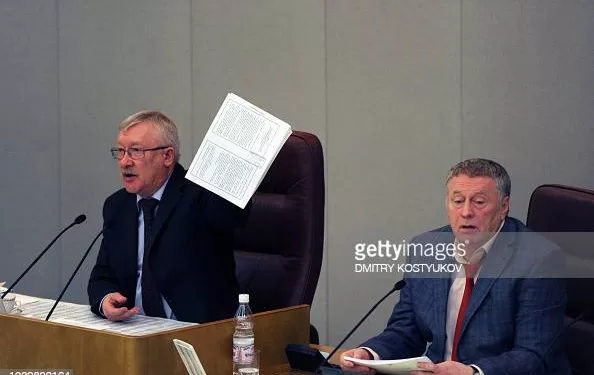 Russian lower house, the State Duma, vice-chairman Oleg Morozov (L) speaks to lawmakers holding a copy of the new Strategic Arms Reduction Treaty (START)  before the first reading vote on the treaty in Duma, in Moscow , on December 24, 2010, with Liberal Democratic Party Leader, Duma vice-chairman, Vladimir Zhirinovsky (R) attending. Russia's lower house of parliament on Friday gave initial backing to a historic treaty with the US to slash the nuclear arsenals of the Cold War foes but warned final ratification would drag into next year. Although the ultra-nationalist Liberal Democratic Party and the Communists voted against the treaty, the dominance of pro-Kremlin ruling party United Russia means that the main doubt has been when, rather than if, parliament will ratify the accord. AFP PHOTO / DMITRY KOSTYUKOV (Photo by DMITRY KOSTYUKOV / AFP) (Photo by DMITRY KOSTYUKOV/AFP via Getty Images)