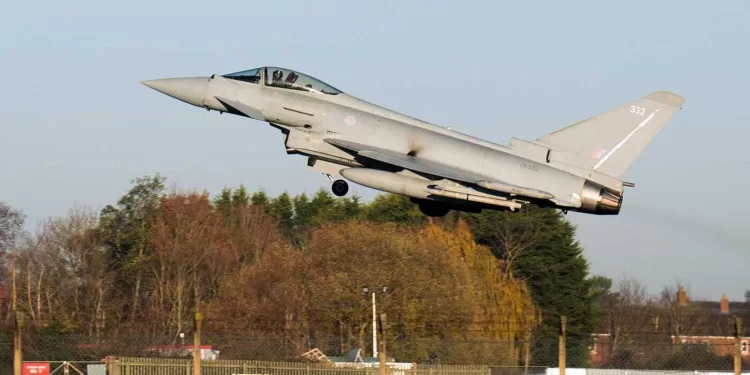 An RAF pilot takes off in a Typhoon fighter jet at Royal Air Force base RAF Coningsby, near Lincoln, eastern England, on December 9, 2022, during a visit by Britain's Prime Minister. - Japan, Britain and Italy said Friday they will jointly develop a next-generation fighter jet, in a project that holds scope for future cooperation with allies including the United States. The new jet project called Tempest, to be ready by 2035, is expected to merge the nations' current research into cutting-edge air combat technology, from stealth capacity to high-tech sensors. (Photo by Joe Giddens / POOL / AFP)