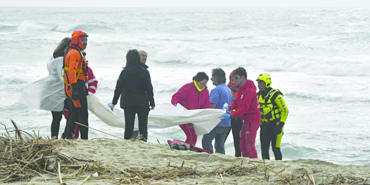 epa10491832 Italian firefighters and Red Cross personnel gather at the scene where bodies of migrants washed ashore following a shipwreck, at a beach near Cutro, Crotone province, southern Italy, 26 February 2023. Italian authorities said on 26 February that at least 30 bodies were found on the beach and in the sea near Crotone, in the southern Italian region of Calabria, after a boat carrying migrants sank in rough seas near the coast. About forty people survived the accident, Italian firefighters added. Authorities fear the death toll will climb as rescuers look for survivors.  EPA/GIUSEPPE PIPITA