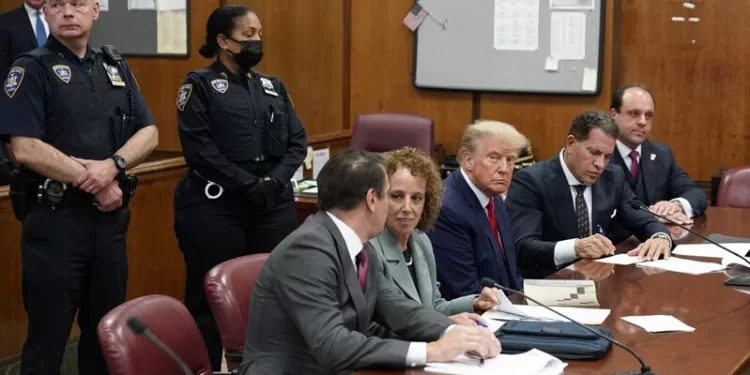 NEW YORK, NEW YORK - APRIL 04: Former U.S. President Donald Trump sits at the defense table with his defense team in a Manhattan court during his arraignment on April 4, 2023, in New York City. Trump was arraigned during his first court appearance today following an indictment by a grand jury that heard evidence about money paid to adult film star Stormy Daniels before the 2016 presidential election. With the indictment, Trump becomes the first former U.S. president in history to be charged with a criminal offense.   Seth Wenig-Pool/Getty Images/AFP (Photo by POOL / GETTY IMAGES NORTH AMERICA / Getty Images via AFP)