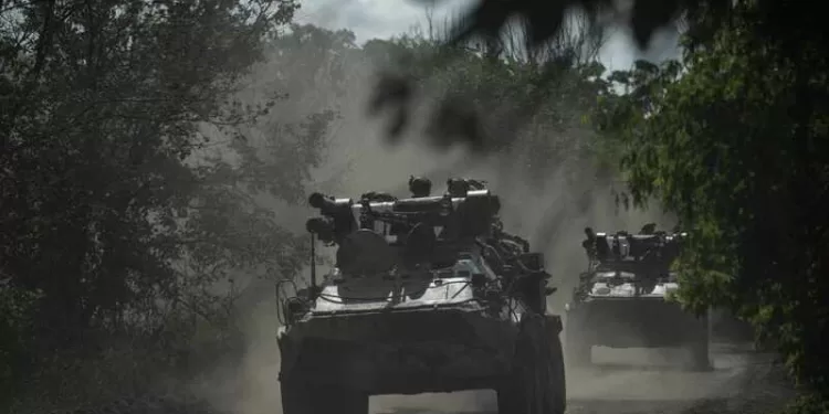 Ukrainian servicemen ride on armoured personnel carriers (APC) on a road toward Bakhmut, Donetsk region, on July 1, 2023, amid the Russian invasion of Ukraine. (Photo by Genya SAVILOV / AFP)